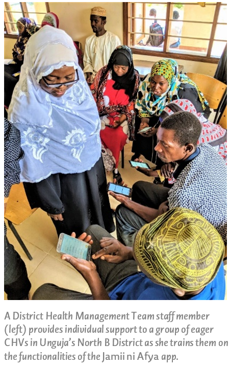 A District Health Management Team staff member (left) provides individual support to a group of eager CHVs in Unguja’s North B District as she trains them on the functionalities of the Jamii ni Afya app.