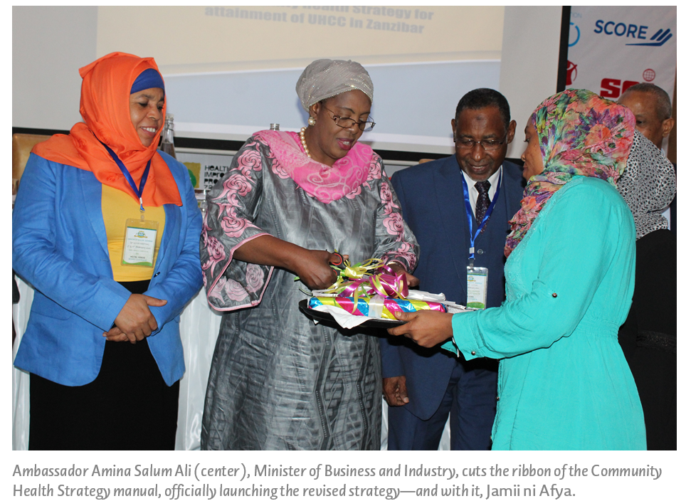 Ambassador Amina Salum Ali (center), Minister of Business and Industry, cuts the ribbon of the Community Health Strategy manual, officially launching the revised strategy—and with it, Jamii ni Afya. 